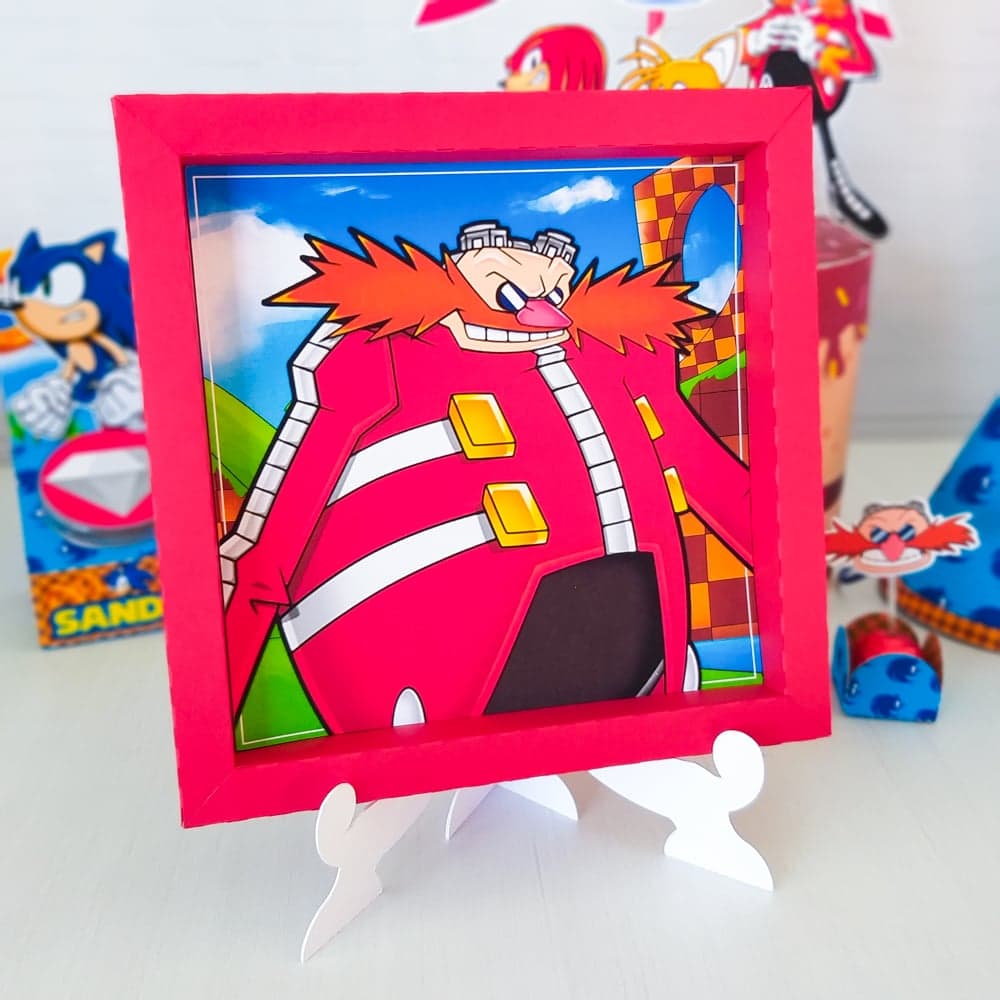 Quadro decorativo do tema Sonic em moldura vermelha, apoiado sobre um pequeno cavalete, com ilustração do personagem Knuckles